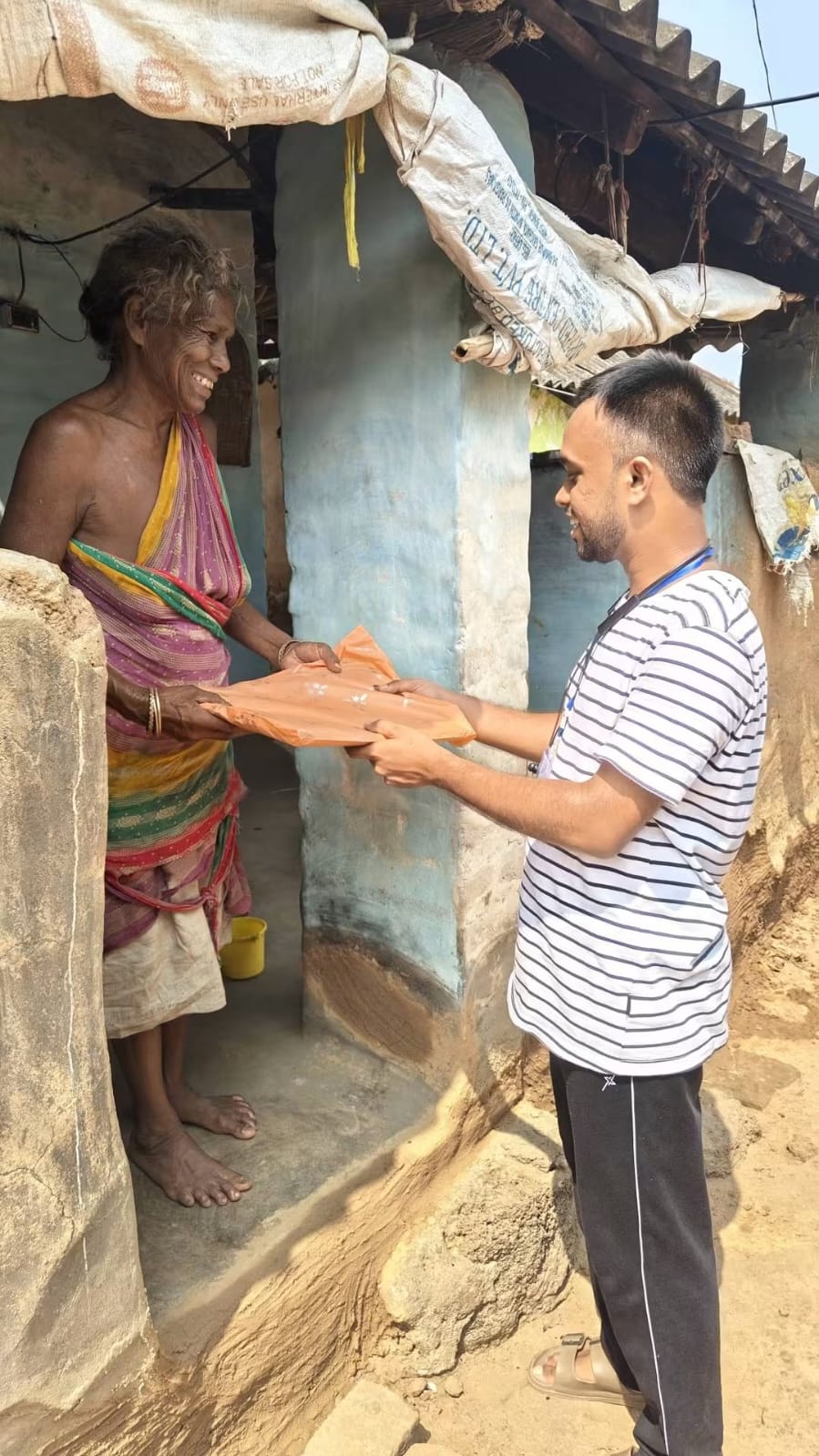 Elderly woman receiving new clothes in Onda