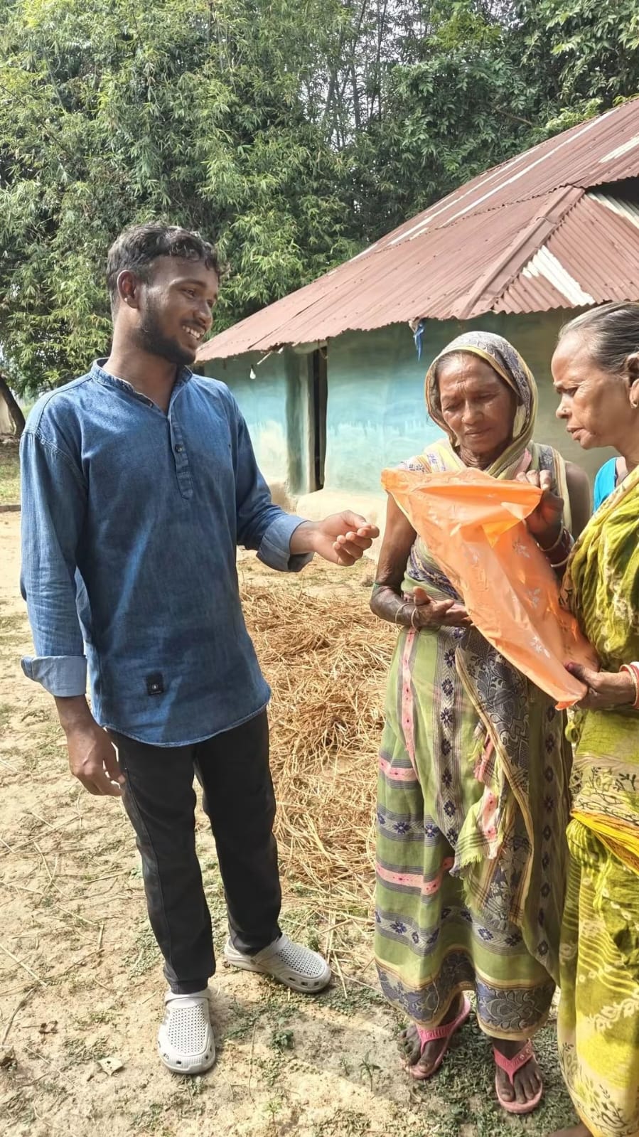 Woman in an orange saree receiving a gift
